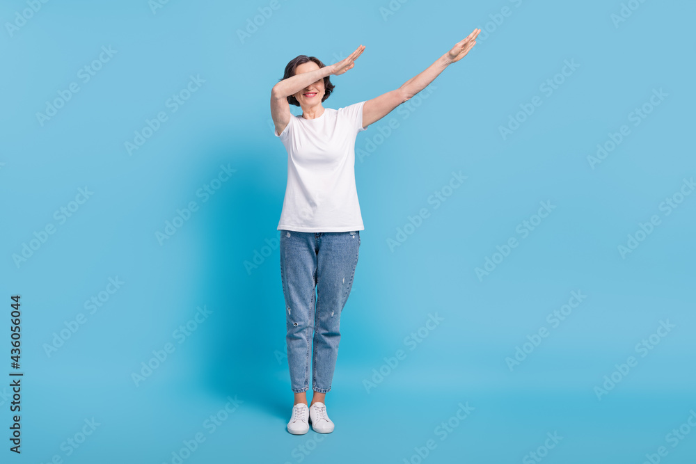 Full length body size photo elder woman dancing showing dab sign in casual clothes isolated on pastel blue color background Full length body size photo elder woman dancing showing dab sign in casual clothes isolated on pastel blue color background