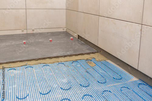 Bild auf Leinwand Renovation and improvement concept, Installing a floor heating system under cera