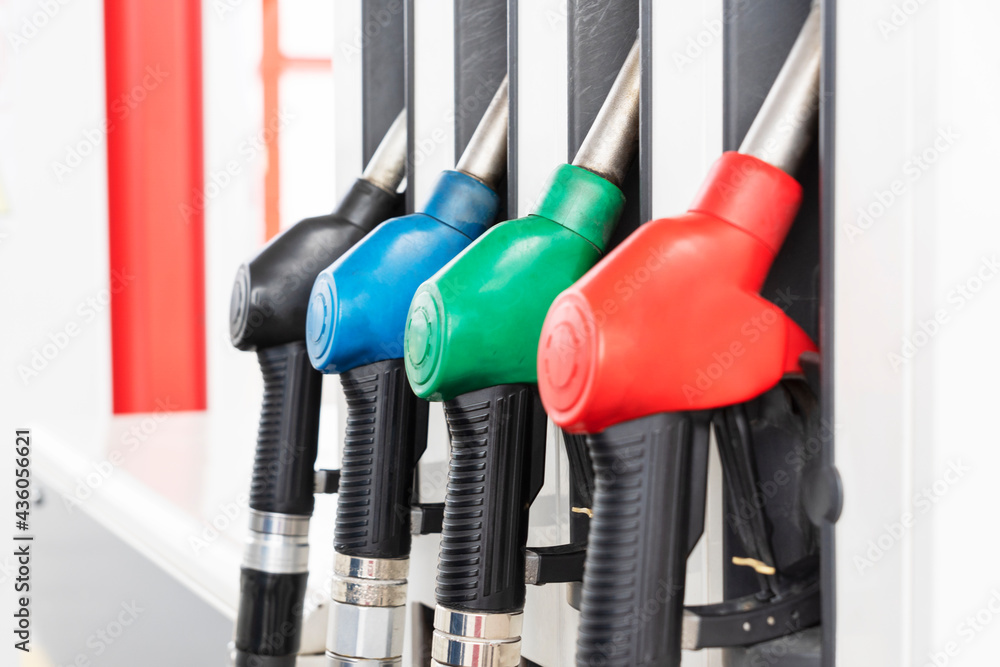 Close up image of four gas pumps with different types of fuel on gas station. Refueling of cars process. Close up image of four gas pumps with different types of fuel on gas station. Refueling of cars process.