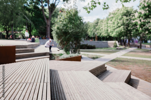 Fototapeta Modern benches and wooden stairs in city on a sunny day