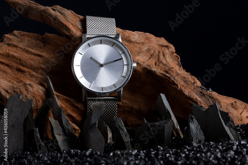 A minimalistic steel/silver watch in a classic product shot setting