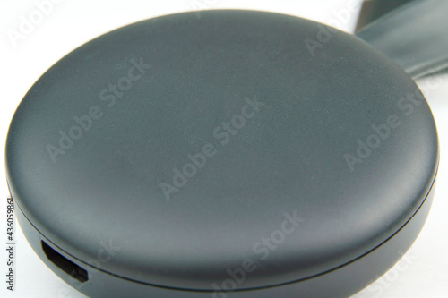 Chromecast media streaming player device on white background. Selective focus. Macro photo