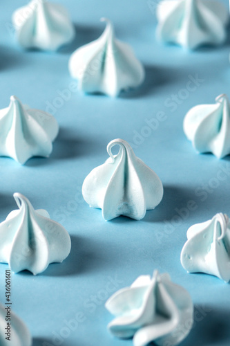 Small spiral meringues on blue background