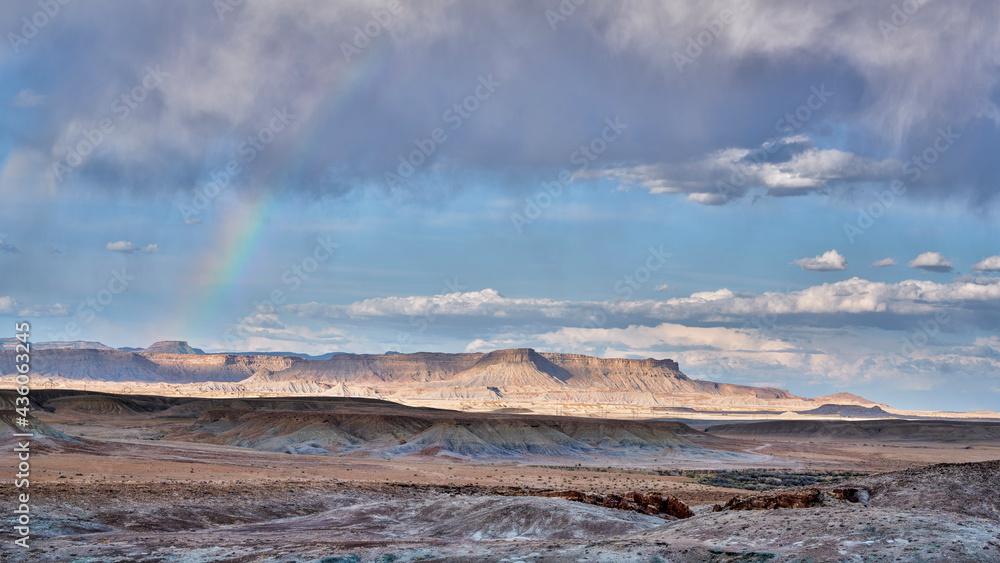 arid desert landscape with a rainbow in Utah near town of Green River