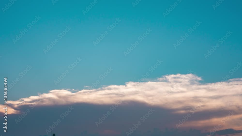 Sunset sky in blue sky. Bright orange sunlight shine through dramatic clouds. Sunset sky in blue sky. Bright orange sunlight shine through dramatic clouds.
