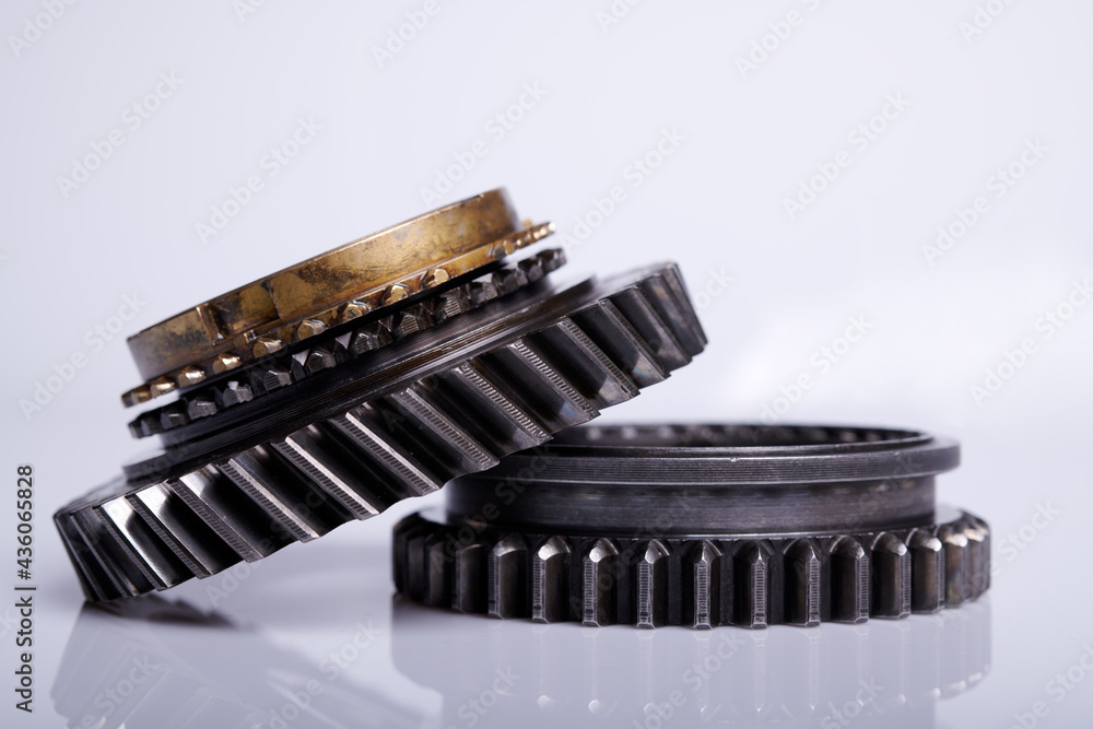 Parts on a gray background. Gears of gear shifting torque transmission. Old gear box parts. Parts on a gray background. Gears of gear shifting torque transmission. Old gear box parts.
