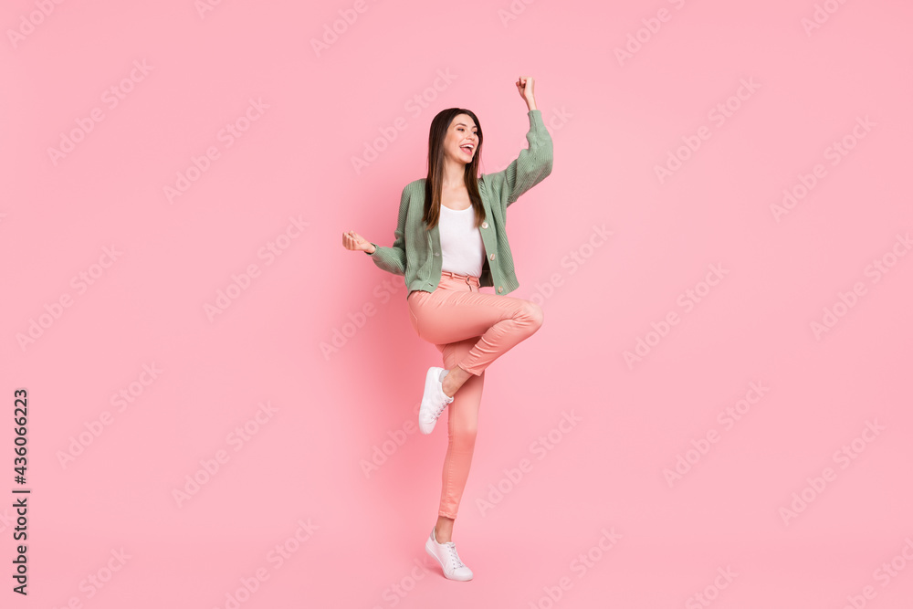 Full size photo of hooray girl dancing wear sweater trousers sneakers isolated on pink color background Full size photo of hooray girl dancing wear sweater trousers sneakers isolated on pink color background