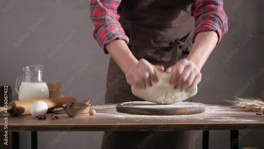 Baker man making dough and bakery ingredients for homemade bread cooking on table. Bakery concept and male hand Baker man making dough and bakery ingredients for homemade bread cooking on table. Bakery concept and male hand