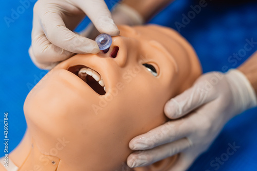 Doctor in operating theater demonstrates the insertion of a nasal tube for ventilation of patient via nose using. Close up - first aid