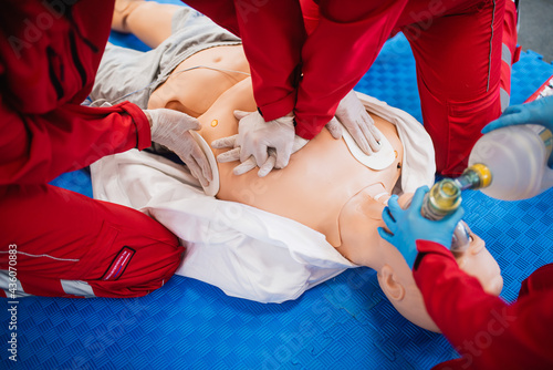 Paramedics revive a man - a doll after a car accident. First aid exercise photo