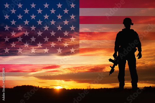 Silhouette of a soldiers against the sunrise and flag USA. Concept - protection, patriotism, honor.