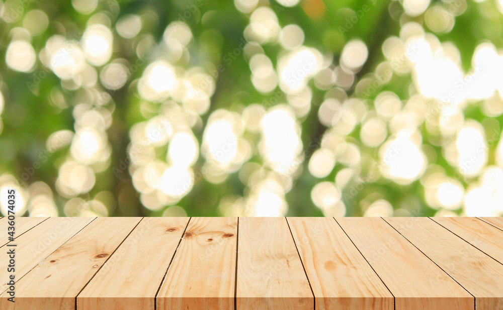 Wood floor with blurred trees of nature park background and summer season, product display montage Wood floor with blurred trees of nature park background and summer season, product display montage