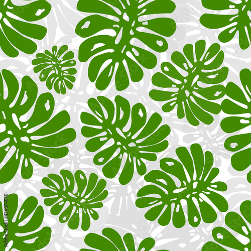 Simple seamless pattern with green tropical leaves.