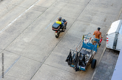 top view of a homeless man pulling a garbage cart on the streets in Brazil