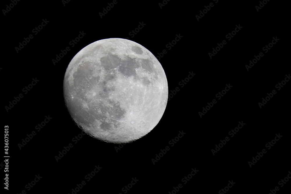 Full white moon glowing isolated on the black background Full white moon glowing isolated on the black background