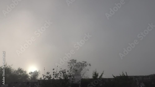 Time Lapse Foggy Morning X20 in a Back yard as the Sun Comes up with the Fog Burning off and Movement of Mist showing the Evaporation of Clouds by Direct Sunlight photo