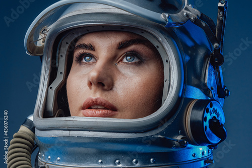 Female modern cosmonaut in spacesuit and helmet © Fxquadro