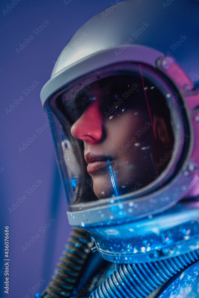 Profile shot of spacewoman inside room with abstract light Profile shot of spacewoman inside room with abstract light