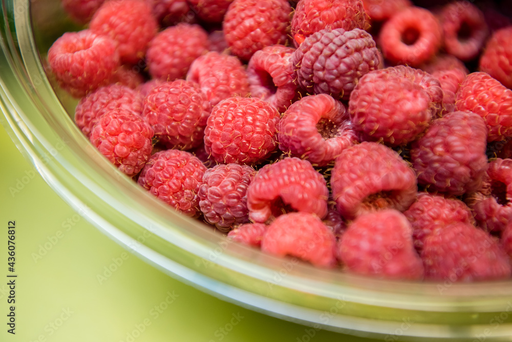 Rasberries in a serving bowl. Macro view from the top Rasberries in a serving bowl. Macro view from the top