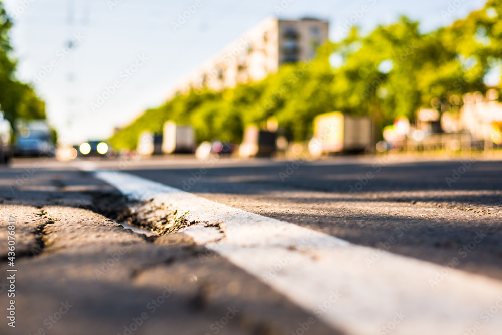 Sunny day in a city, view of the flow of cars to the road level Sunny day in a city, view of the flow of cars to the road level