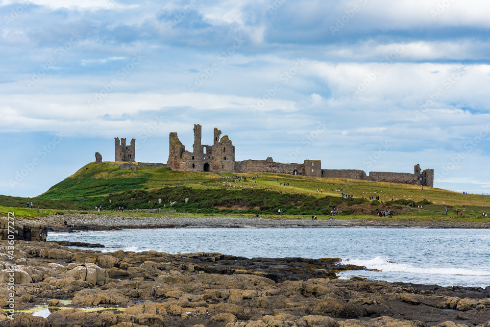 Dunstanburgh Castle, Northumberland, England, UK from the path to Craster