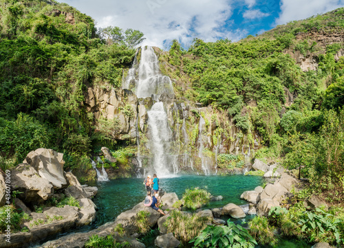 Beautiful nature landscape with a high waterfall and fresh forest in the summertime in Reunion island