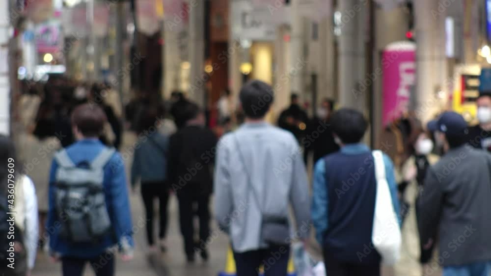 OSAKA, JAPAN - APRIL 2021 : Crowd of people wearing surgical masks to protect from Coronavirus (COVID-19) at in busy rush hour. View around Namba, Shinsaibashi downtown shopping street. OSAKA, JAPAN - APRIL 2021 : Crowd of people wearing surgical masks to protect from Coronavirus (COVID-19) at in busy rush hour. View around Namba, Shinsaibashi downtown shopping street.