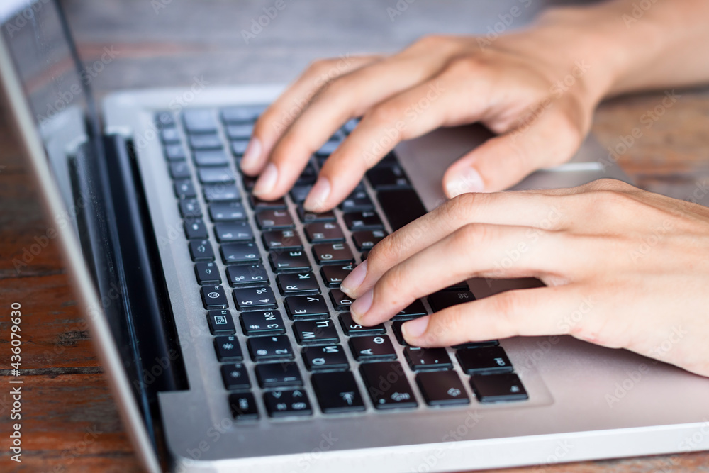 Hands typing on laptop computer keyboard, writing email or contacting people Hands typing on laptop computer keyboard, writing email or contacting people