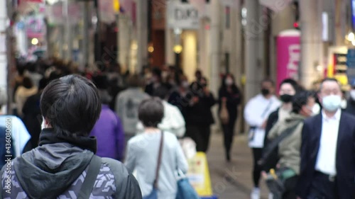 Wallpaper Mural OSAKA, JAPAN - APRIL 2021 : Crowd of people wearing surgical masks to protect from Coronavirus (COVID-19) at in busy rush hour. View around Namba, Shinsaibashi downtown shopping street. Torontodigital.ca