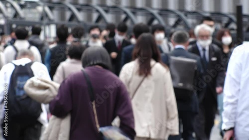Wallpaper Mural OSAKA, JAPAN - APRIL 2021 : Crowd of people wearing surgical masks to protect from Coronavirus (COVID-19) at the street in busy rush hour. View of commuters after work around Osaka train station. Torontodigital.ca