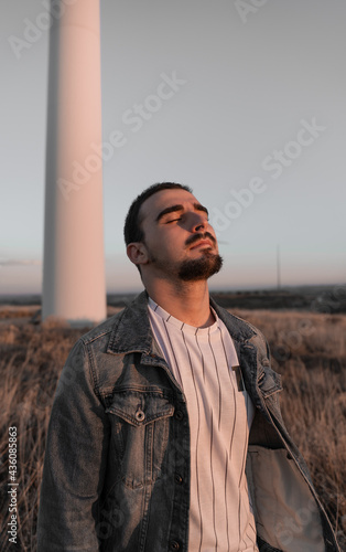 Man is breathing next to a windmill