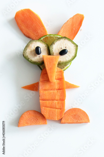 Food art creative concepts. Funny ET made of fruits and vegetables, such as cucumber and carrots isolated on a white background