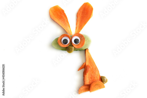 Food art creative concepts. Funny bunny rabbit made of fruits and vegetables, such as carrots and cucumber isolated on a white background.