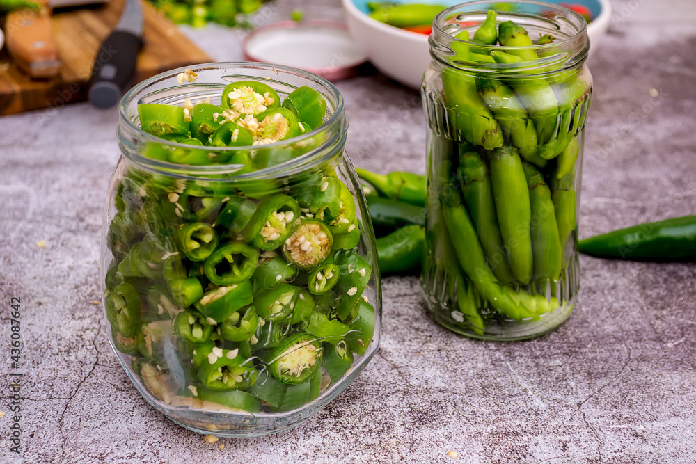 Hot peppers and jalapeno peppers placed in a jar Hot peppers and jalapeno peppers placed in a jar