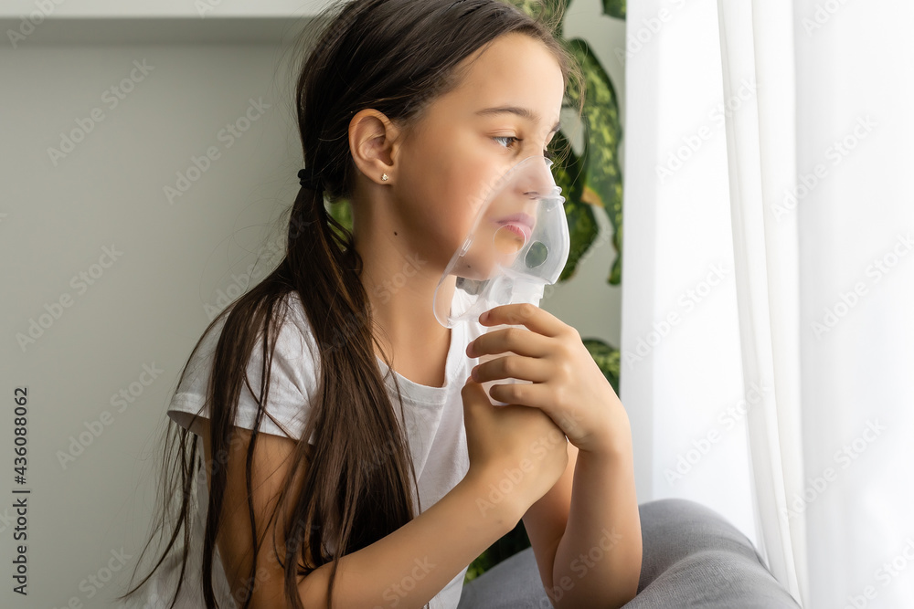 Little girl making inhalation with nebulizer at home. child asthma inhaler inhalation nebulizer steam sick cough concept. Little girl making inhalation with nebulizer at home. child asthma inhaler inhalation nebulizer steam sick cough concept.