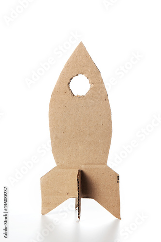 Rocket made of cardboard on a white background. Children art project. DIY concept. Cardboard craft.