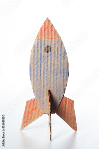 Rocket made of cardboard on a white background. Children art project. DIY concept. Cardboard craft.