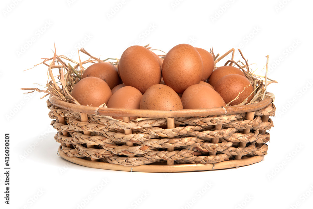 Organic eggs in a straw nest and basket isolated on white background. Organic eggs in a straw nest and basket isolated on white background.