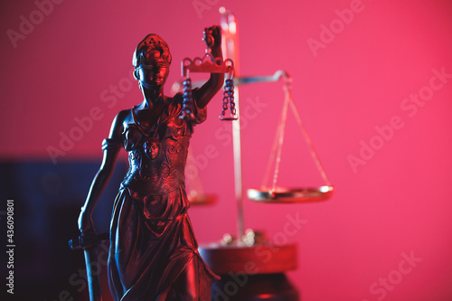 Statue of Lady Justice in red neon. Symbol of justice and law