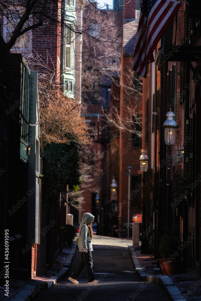 Women walking under the sun on the streets of Beacon Hill