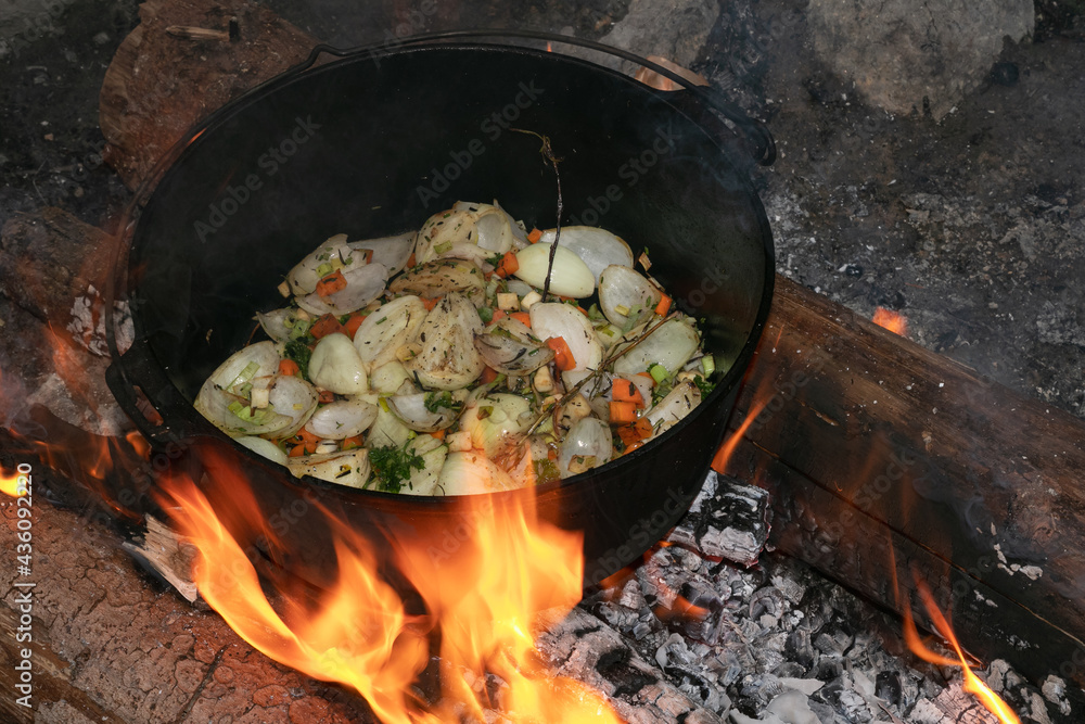 Outdoor cooking in the dutch oven, stir-fried vegetables, campfire recipes Outdoor cooking in the dutch oven, stir-fried vegetables, campfire recipes