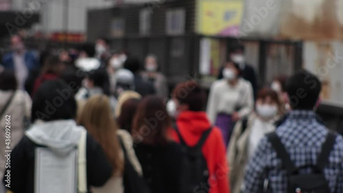 Wallpaper Mural OSAKA, JAPAN - APRIL 2021 : Crowd of people wearing surgical masks to protect from Coronavirus (COVID-19) at the street in busy rush hour. View of commuters after work around Osaka train station. Torontodigital.ca