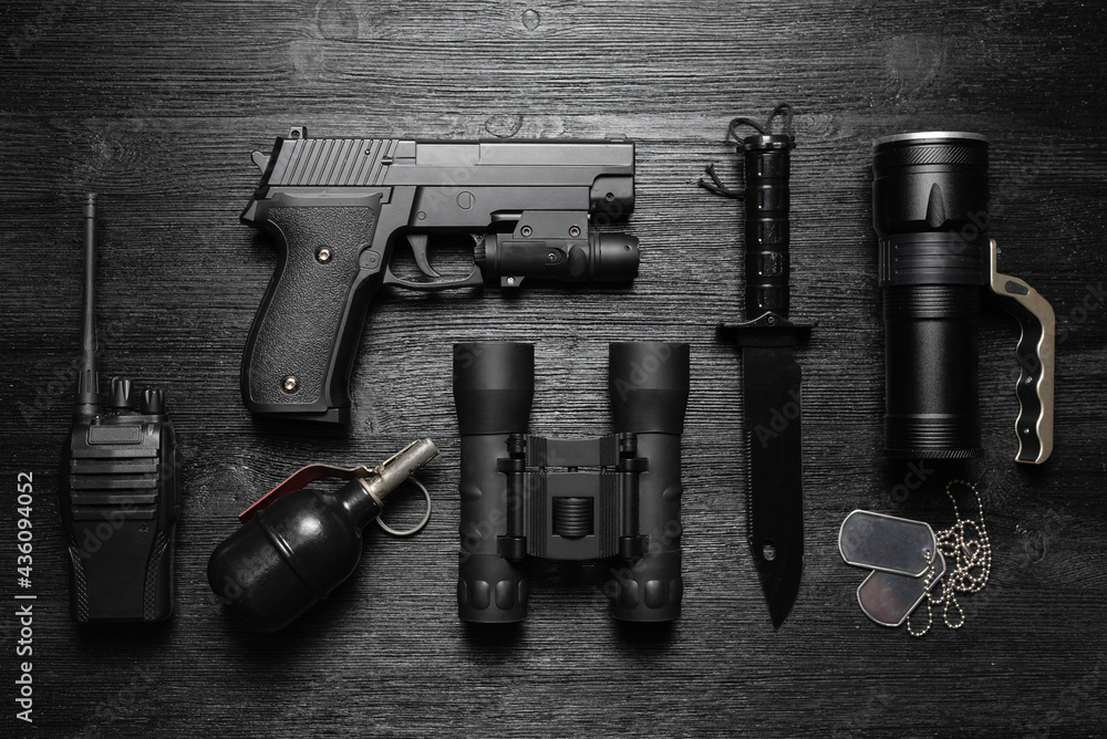 Black airsoft gun, walkie talkie radio station, binoculars, knife and  soldier badge on the black flat lay background. Photos | Adobe Stock