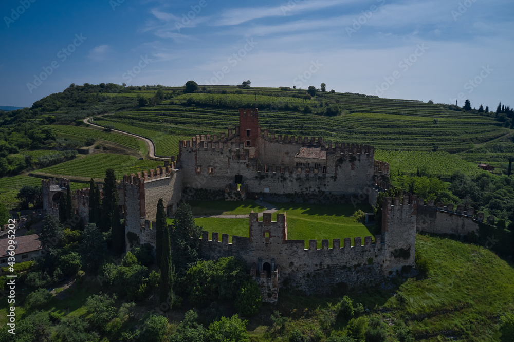The famous medieval castle on the hill. Italian historic castles. Soave castle aerial view, province of Verona, Italy. Aerial panorama of Italy castles.