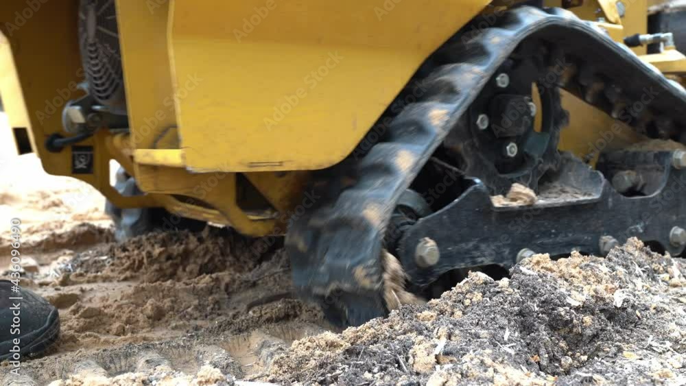 strain cutter wheel chain close view as it moves forward.
A layer of chips and sand can be seen under the stump cutter wheel chains or tracks strain cutter wheel chain close view as it moves forward.
A layer of chips and sand can be seen under the stump cutter wheel chains or tracks