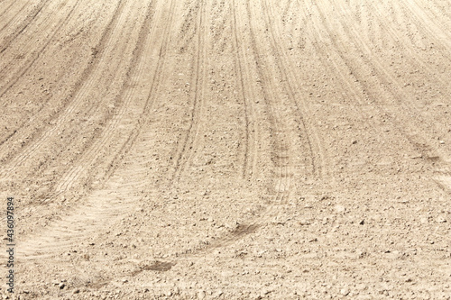 Landscape agricultural land in slope recently plowed for the crop