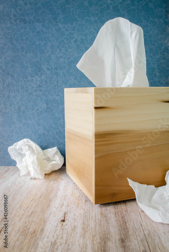 Obraz na plátne A handmade wooden tissue box and tissues bunched up
