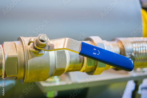 Manual stainless ball valves in pipes for water supply at factory, plant- close up. Industrial, equipment concept
