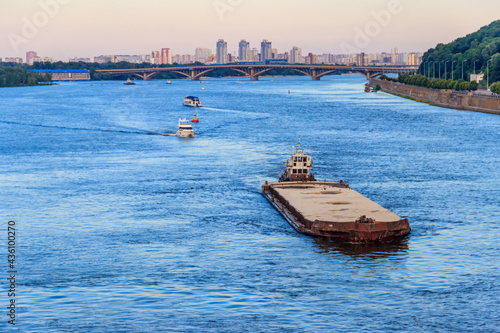 Heavy long barge sailing on the Dnieper river in Kiev, Ukraine