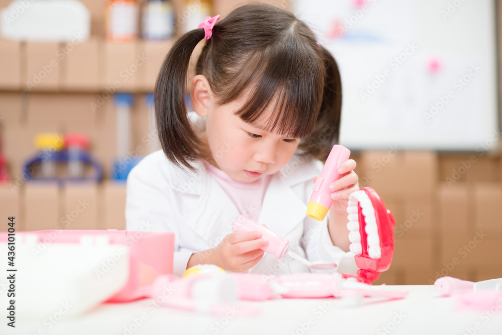 young girl pretend play dentist role at home young girl pretend play dentist role at home